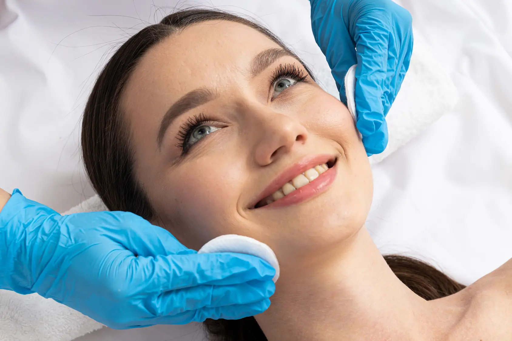 Skincare professional cleansing client’s face before Platelet-Rich Plasma Therapy procedure.