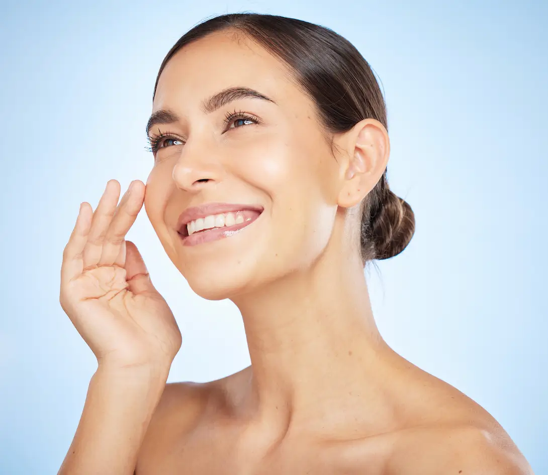 Woman smiling with glowing skin after Intense Pulsed Light Therapy treatment.