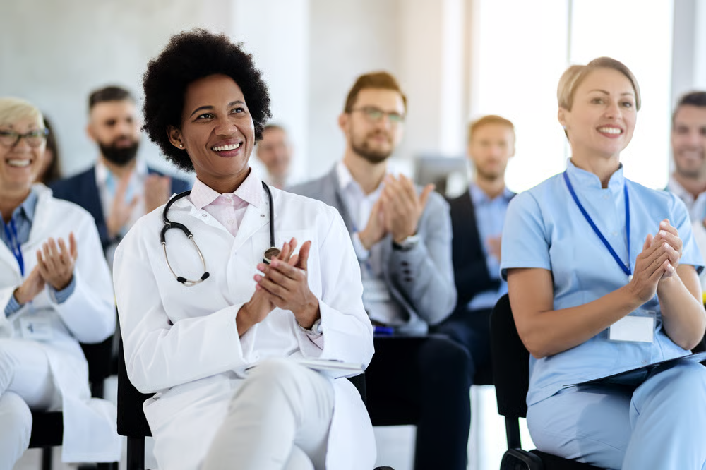 Healthcare professionals applauding during a training event linked to CPCA corporate membership and professional learning.